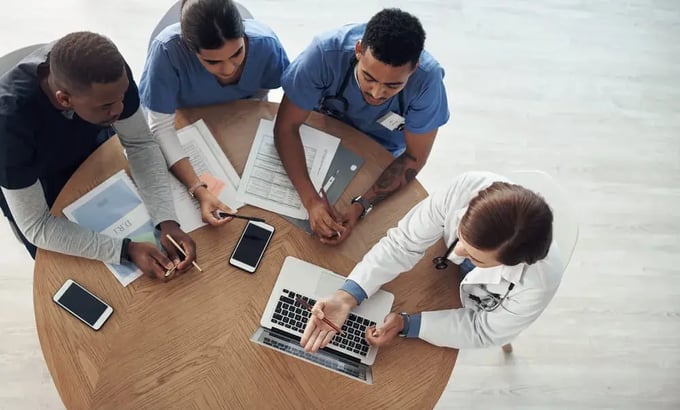 A group of people discussing onboarding challenges.