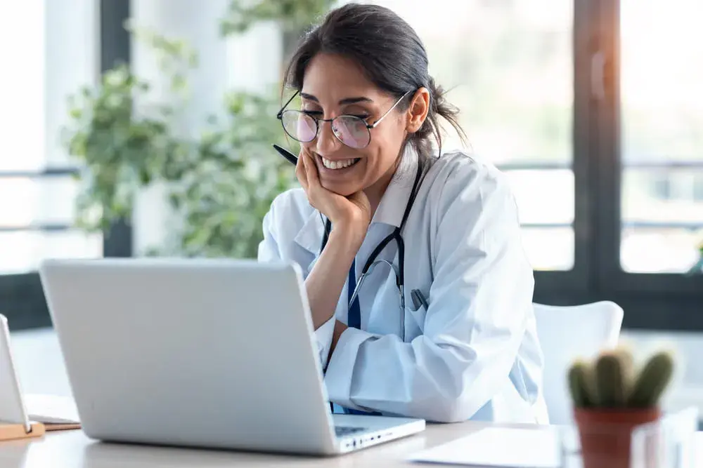 A female doctor looking working on improving patient safety.